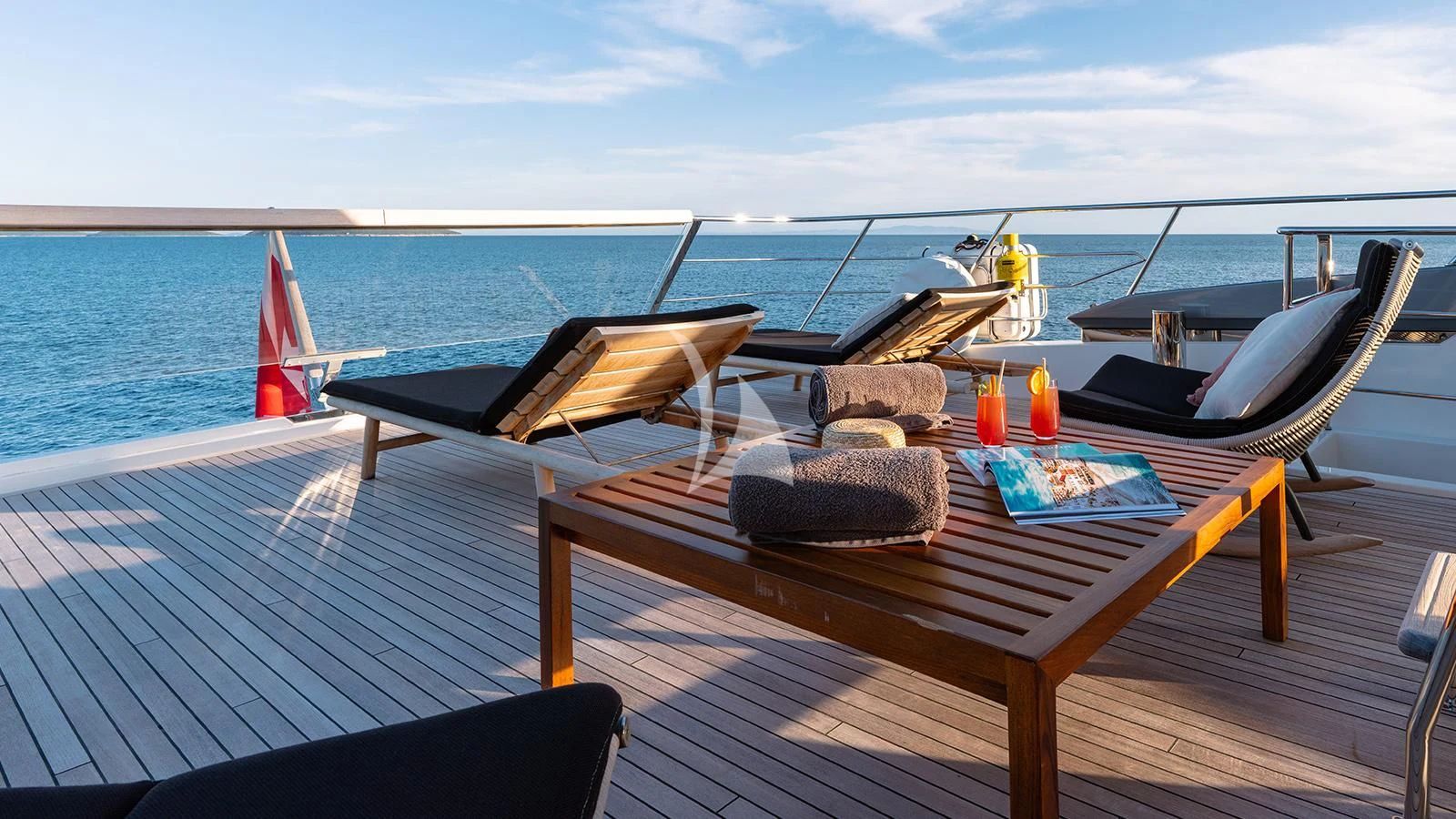 a deck with a boat and chairs on it aboard JOURNEY Yacht for Sale