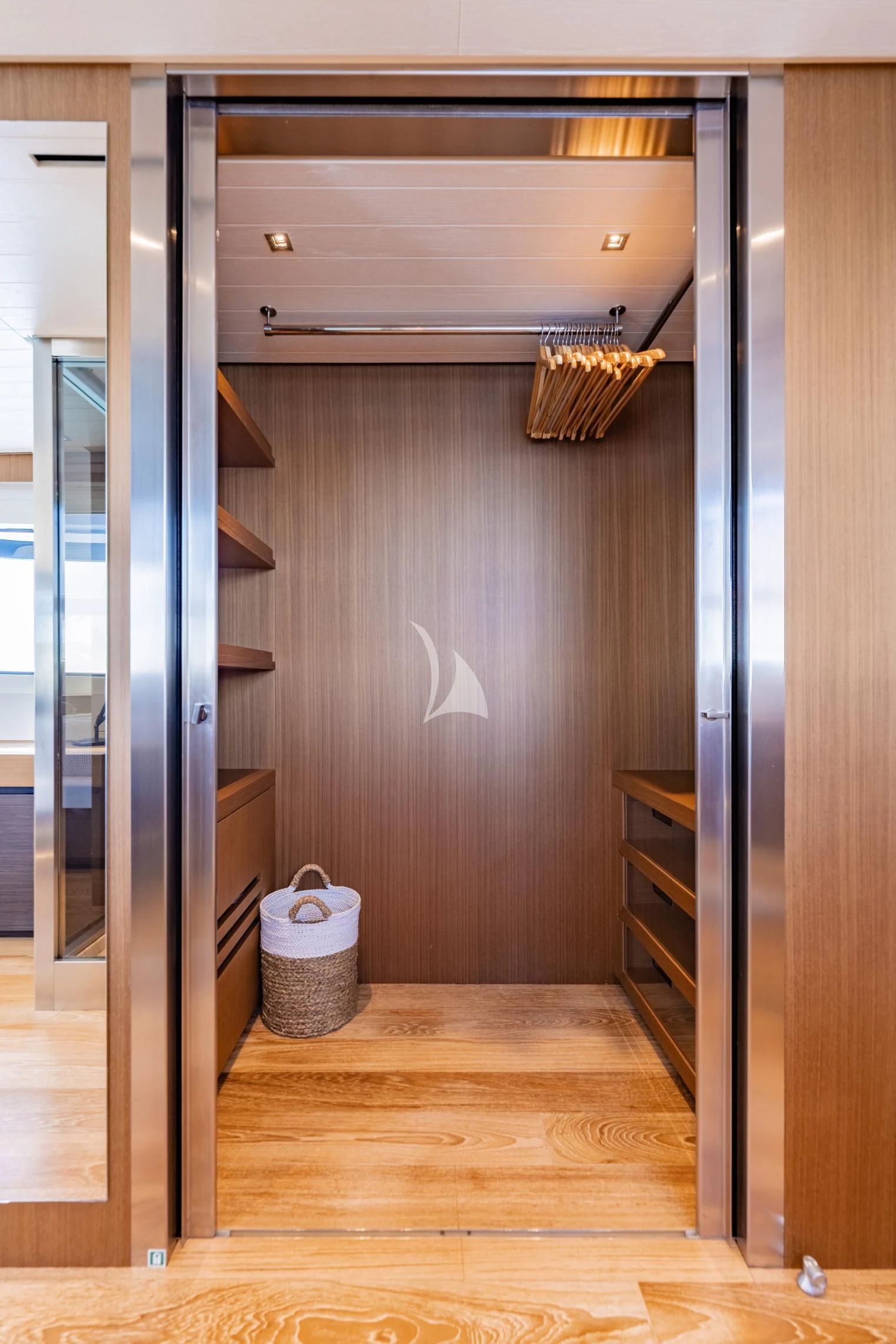 a room with a wood floor and a basket on the floor aboard JOURNEY Yacht for Sale