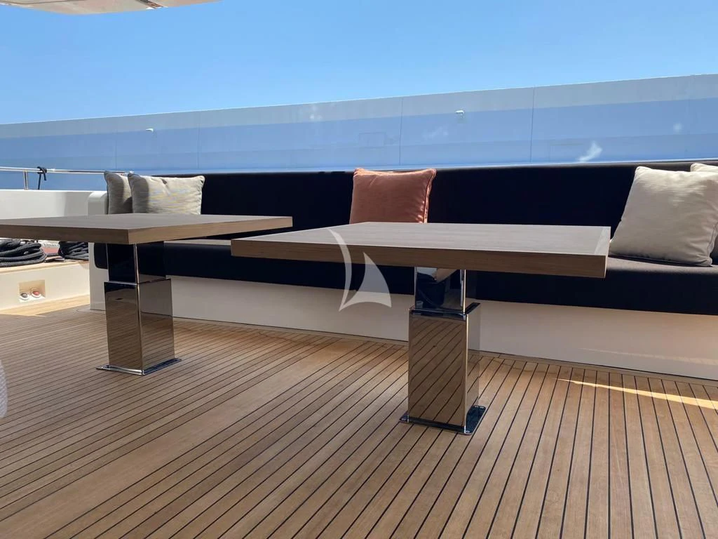 a table and chairs on a deck aboard JOURNEY Yacht for Sale
