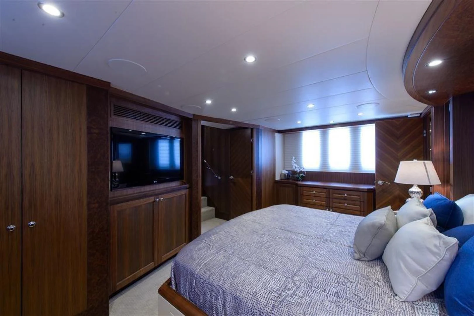 a bedroom with a bed and a television aboard RHONDAVOUS Yacht for Sale