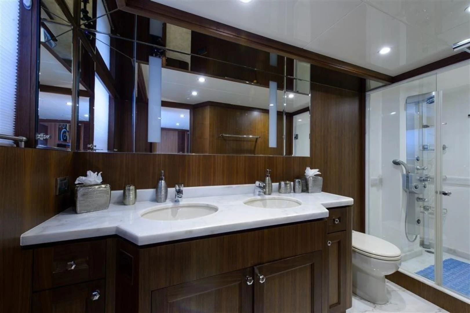 a bathroom with a large mirror aboard RHONDAVOUS Yacht for Sale