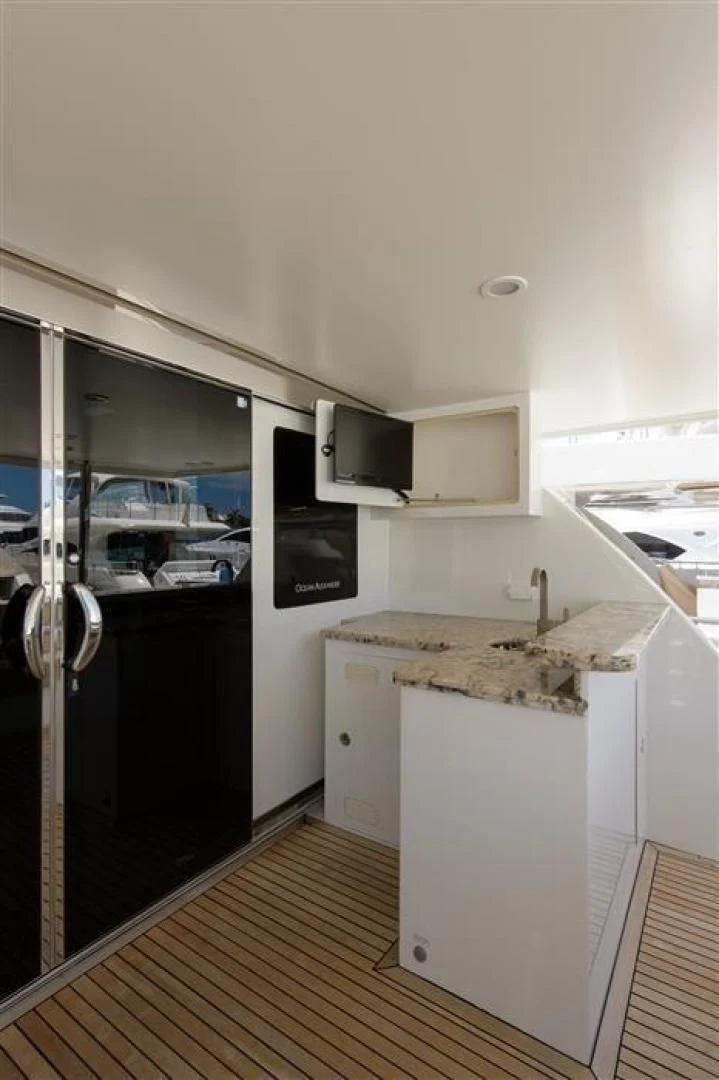 a kitchen with a large refrigerator aboard RHONDAVOUS Yacht for Sale