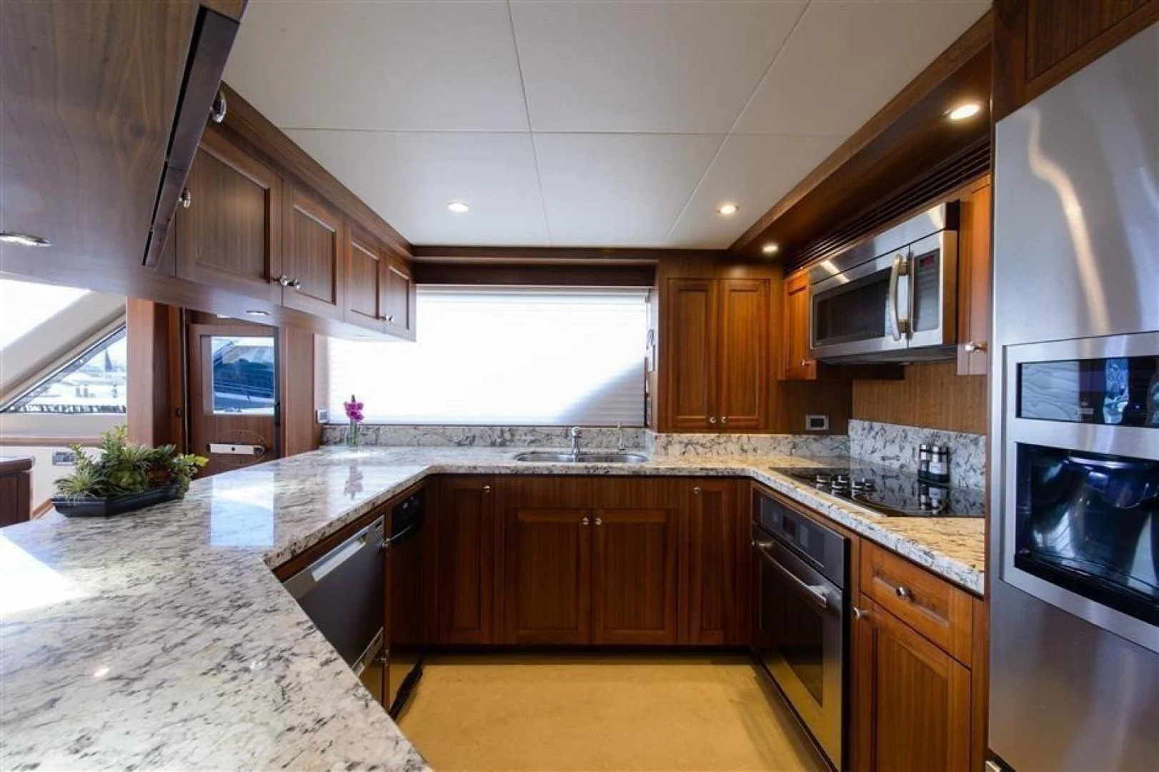 a kitchen with wooden cabinets aboard RHONDAVOUS Yacht for Sale