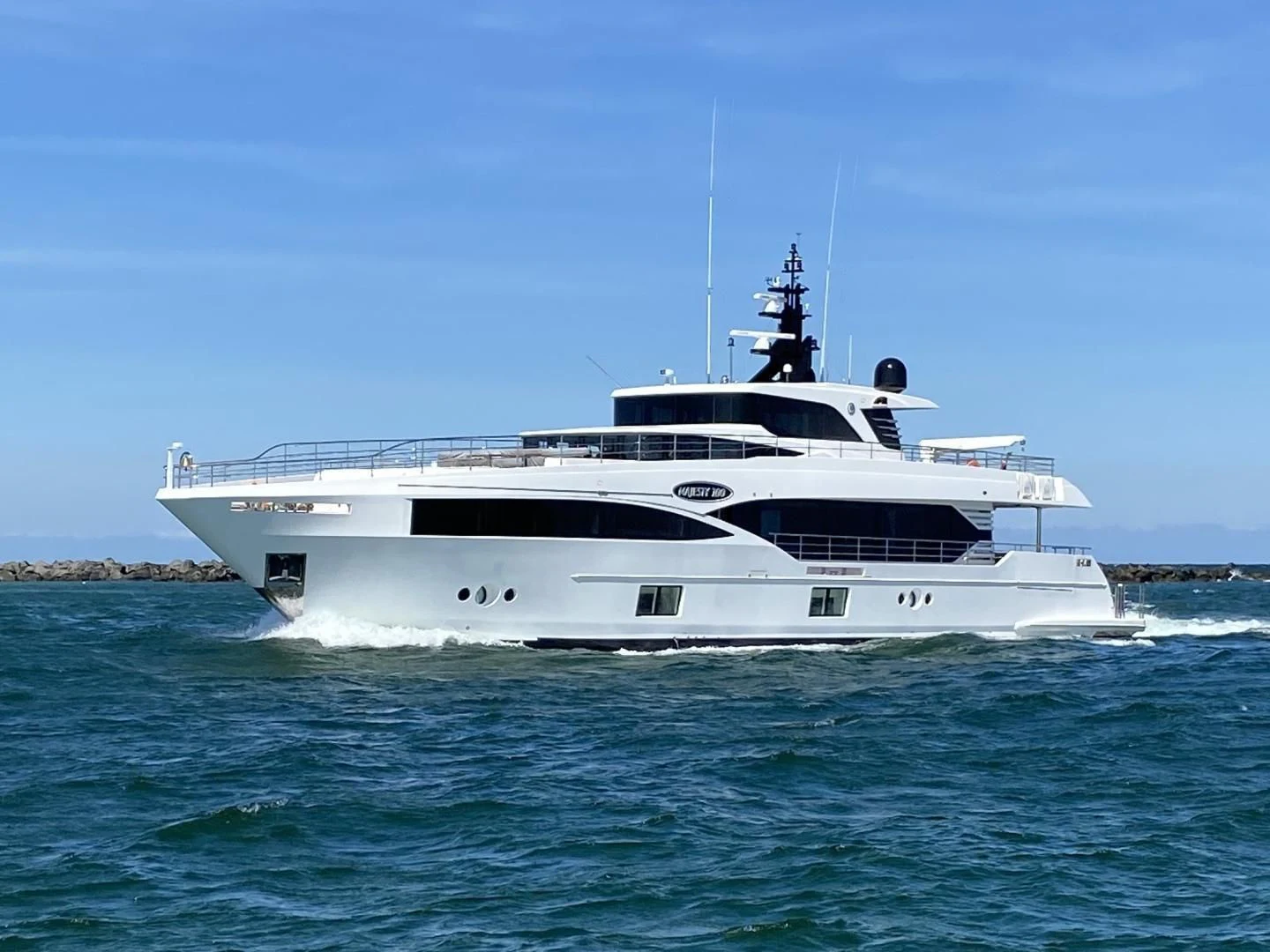 a white boat in the water aboard MAJESTY 100 Yacht for Sale