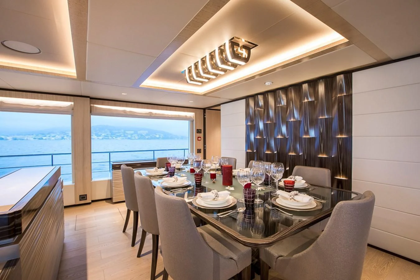 a dining room with a large window aboard MAJESTY 100 Yacht for Sale