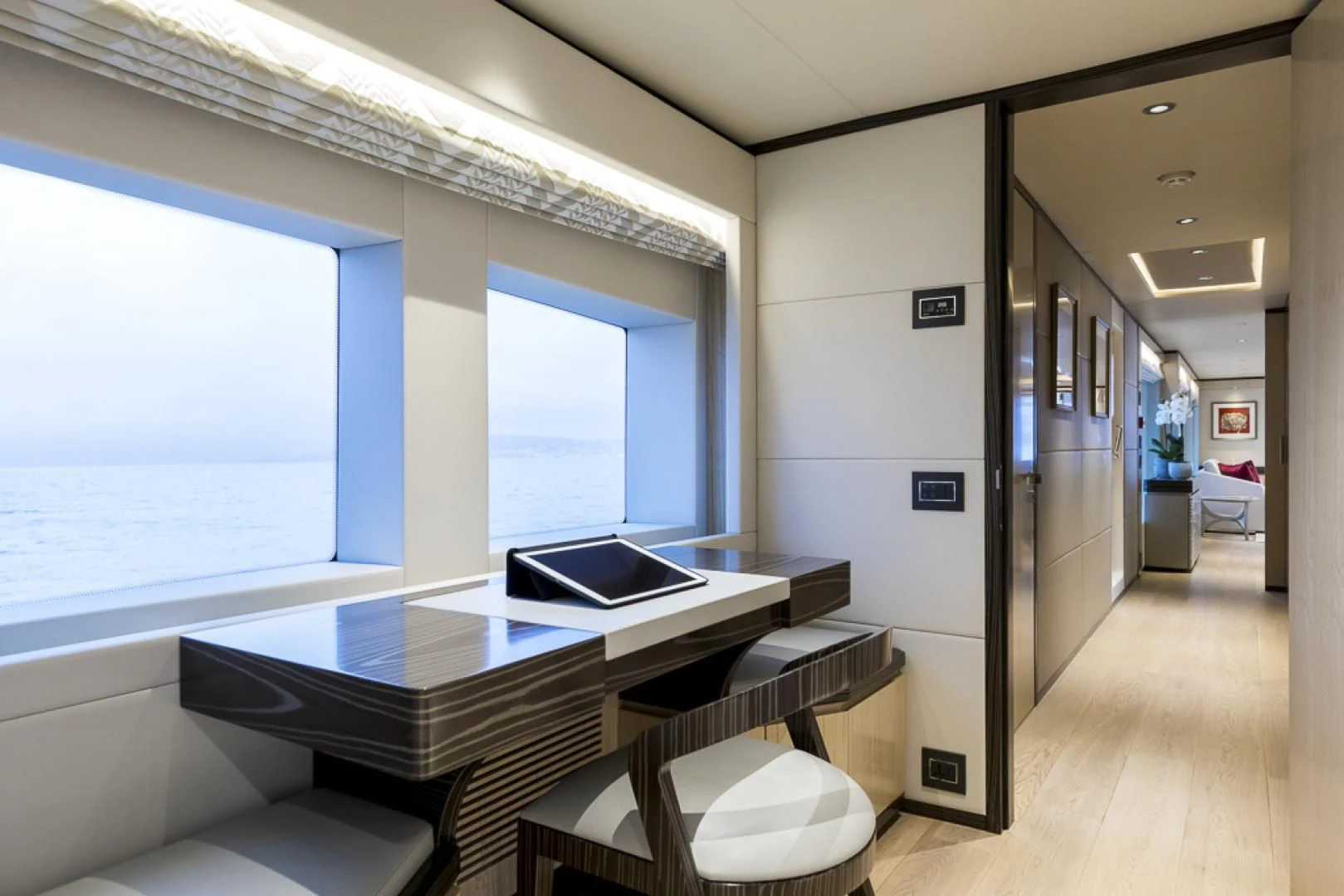 a room with a table and chairs aboard MAJESTY 100 Yacht for Sale