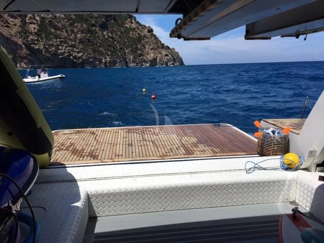 a boat with a net on the deck and a body of water in the background aboard MORE Yacht for Sale