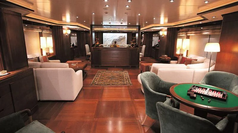a living room with a table and couches aboard MORE Yacht for Sale