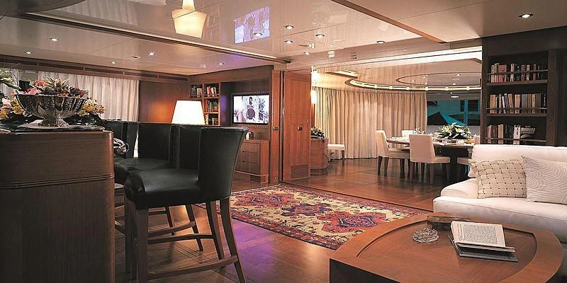 a living room with a large rug aboard MORE Yacht for Sale