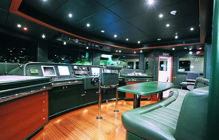 a bar with a bar and a table and chairs aboard MORE Yacht for Sale
