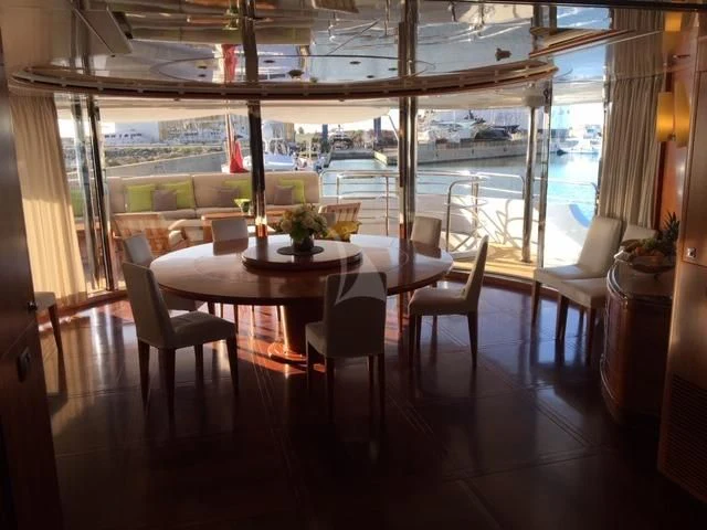 a room with a table and chairs aboard MORE Yacht for Sale