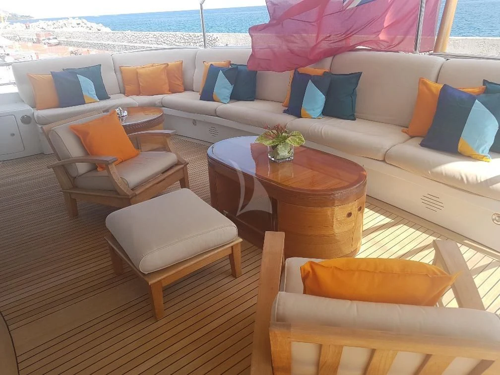 a living room with a couch and a table aboard MORE Yacht for Sale