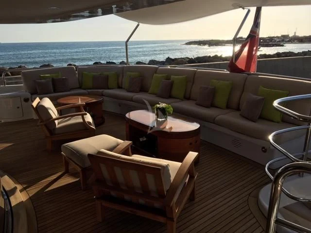 a couch and chairs on a deck aboard MORE Yacht for Sale