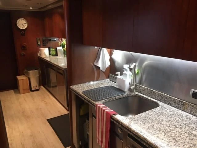 a kitchen with a sink and a microwave aboard MORE Yacht for Sale