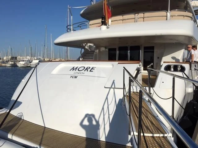 a boat with a person standing on the deck aboard MORE Yacht for Sale