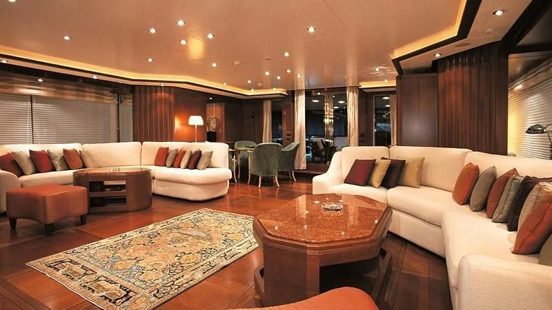 a living room with a couch and a table aboard MORE Yacht for Sale