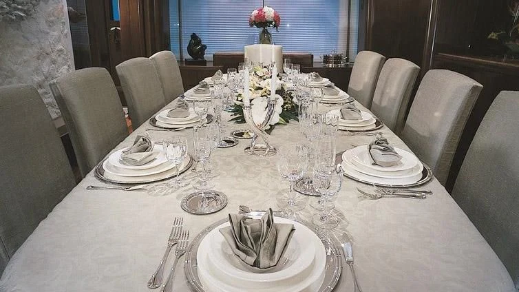 a table set for a dinner aboard MORE Yacht for Sale