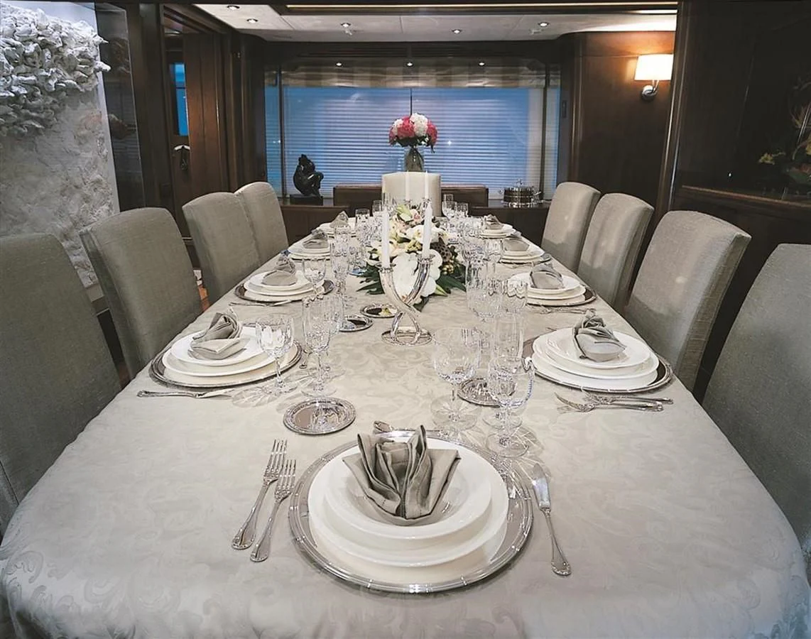 a table set for a dinner aboard MORE Yacht for Sale