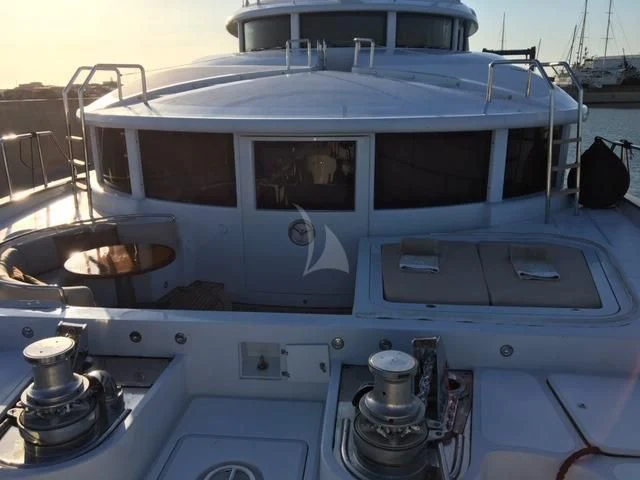 a white boat with a large white sail aboard MORE Yacht for Sale