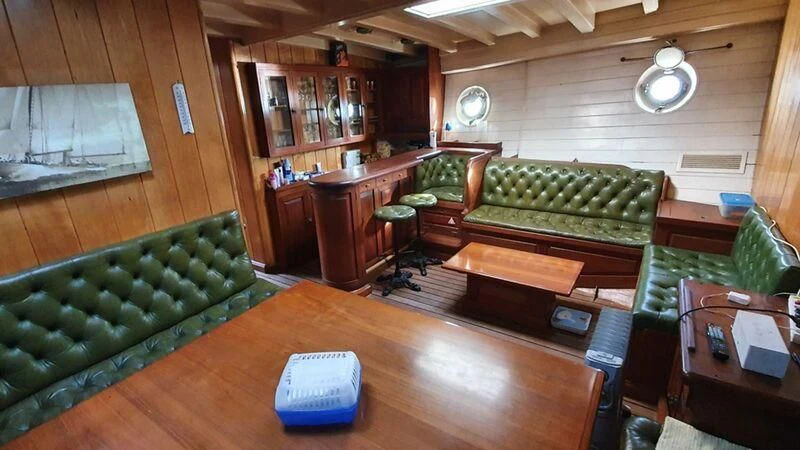 a room with a table and a couch aboard ZACA A TE MOANA Yacht for Sale