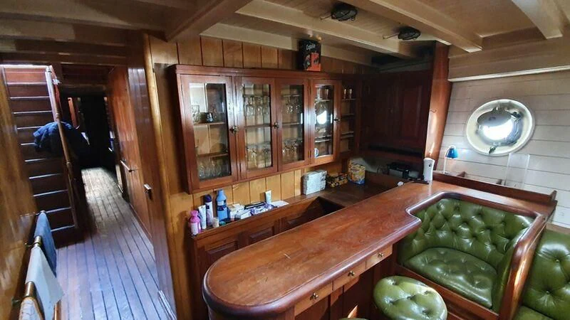 a kitchen with a table and chairs aboard ZACA A TE MOANA Yacht for Sale