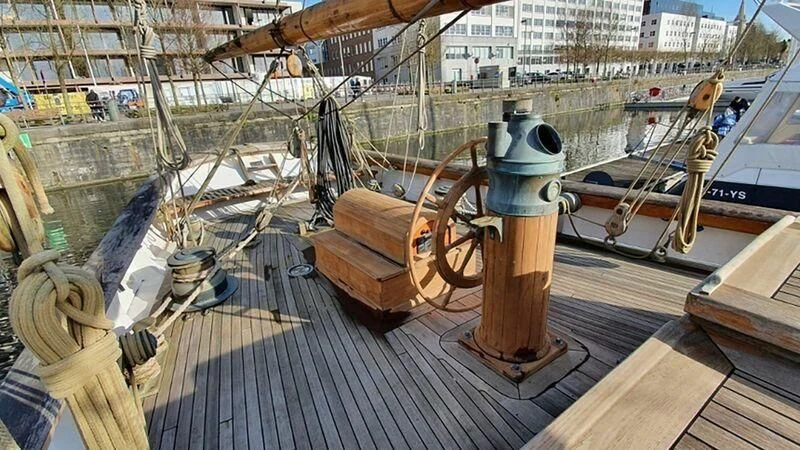 a wooden deck with a metal railing and a metal cylinder on it aboard ZACA A TE MOANA Yacht for Sale