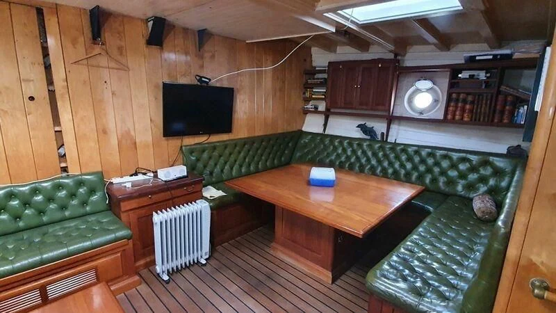 a room with a table and tv aboard ZACA A TE MOANA Yacht for Sale