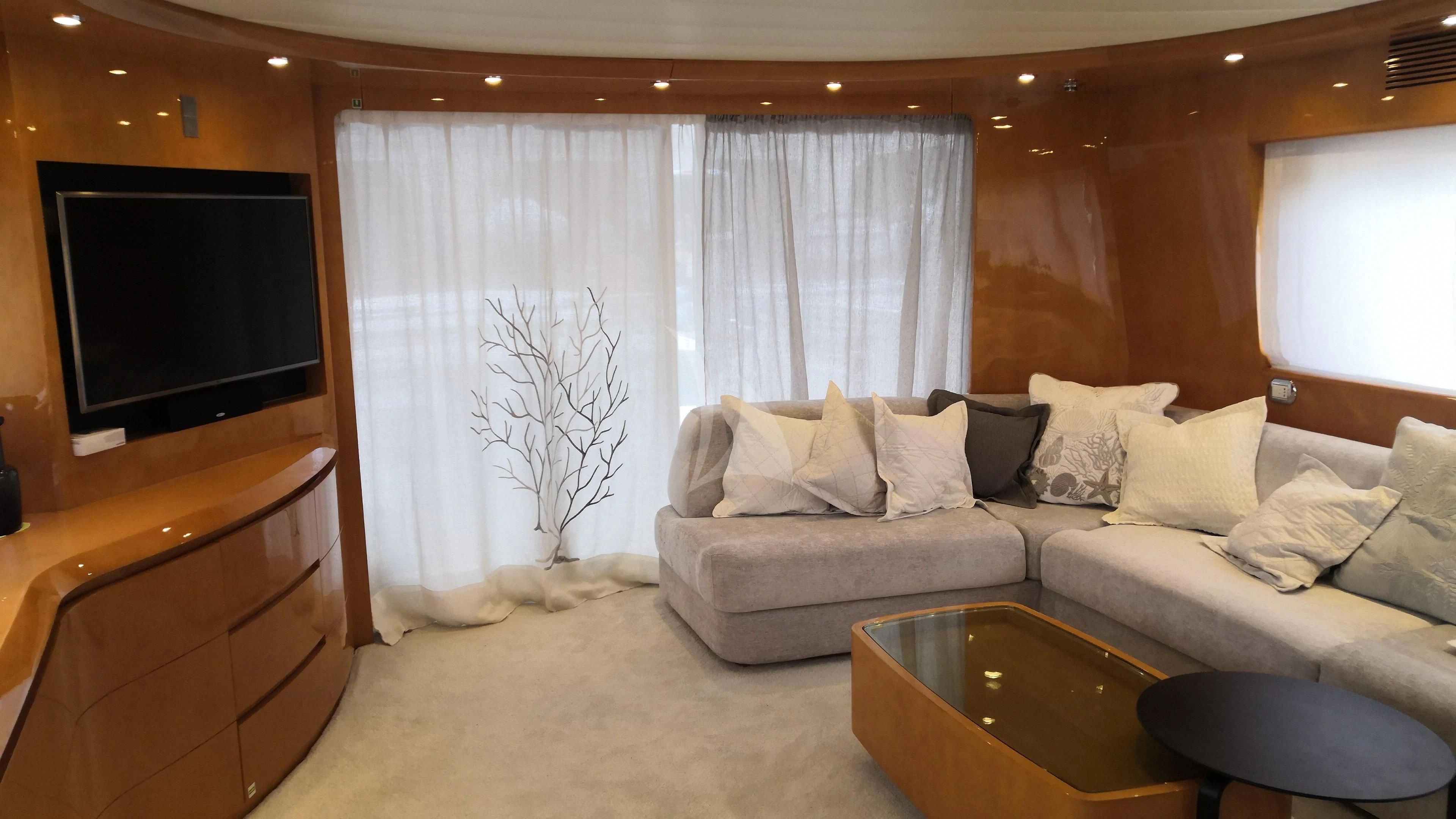 a living room with a couch and a tv aboard WILLFUL Yacht for Sale