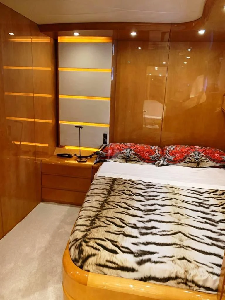 a bedroom with a bed and a mirror aboard WILLFUL Yacht for Sale