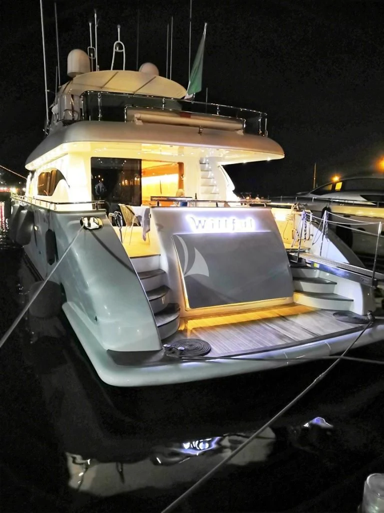 a boat with a flag on the front aboard WILLFUL Yacht for Sale