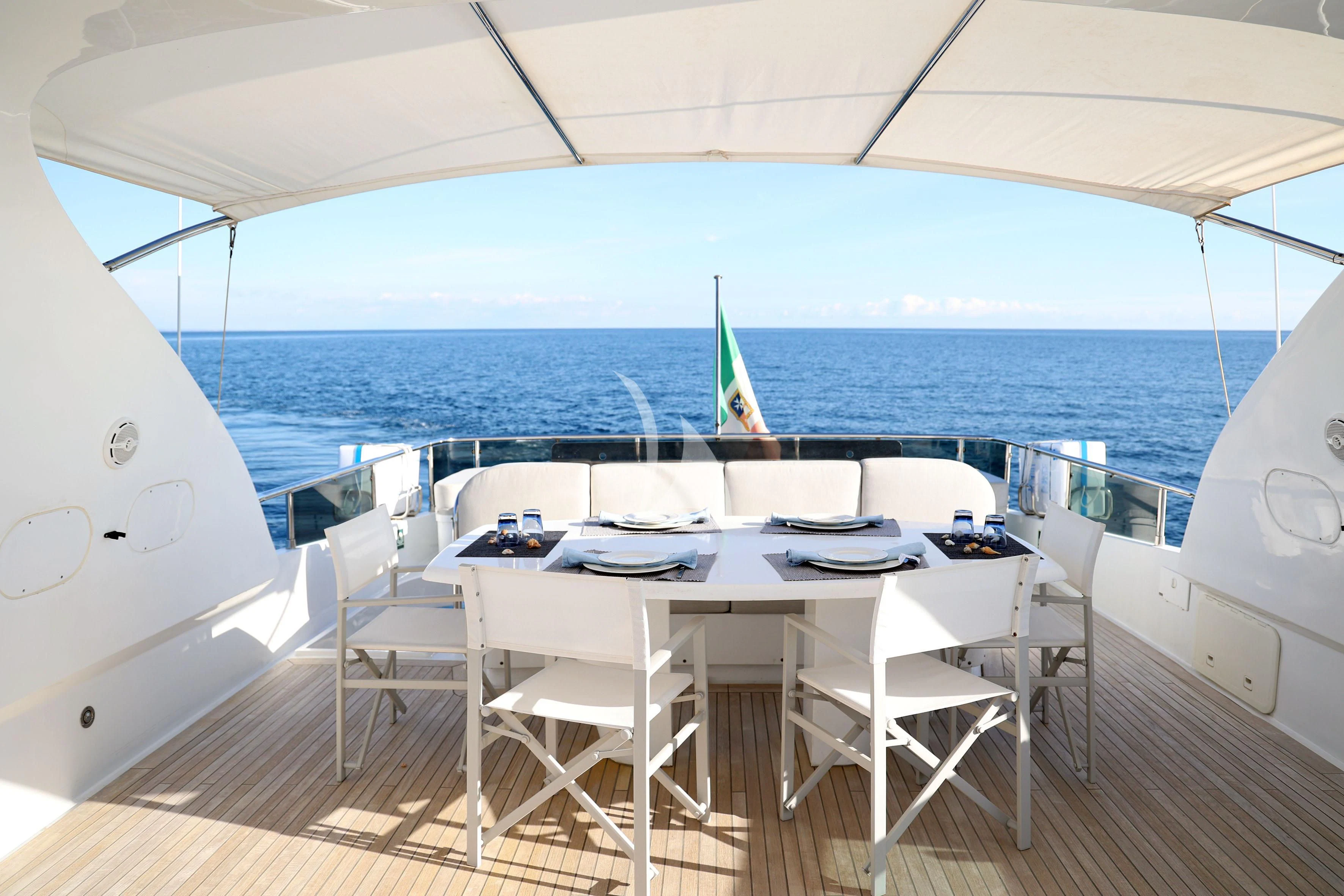 a large white tent with tables and chairs on a deck aboard WILLFUL Yacht for Sale
