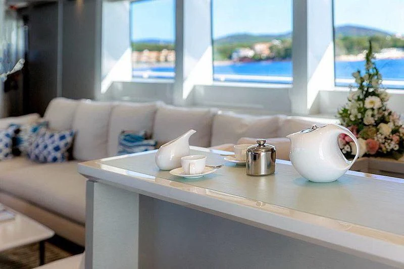 a white coffee table with a tea kettle on it aboard WANDA Yacht for Sale