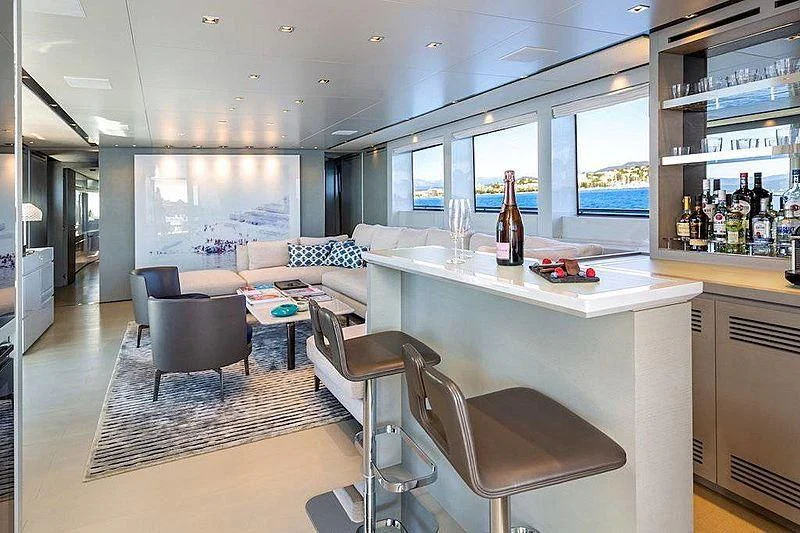a room with a table chairs and a couch aboard WANDA Yacht for Sale