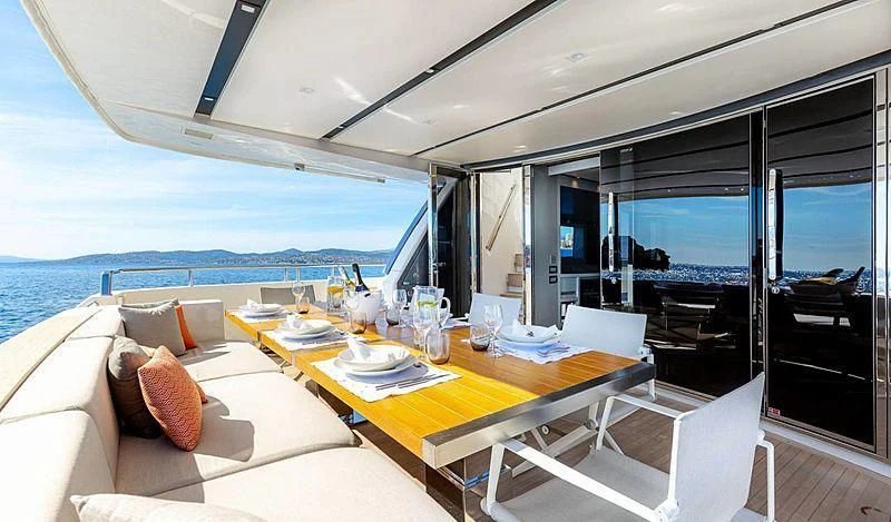 a table with a plate and chairs on it aboard WANDA Yacht for Sale