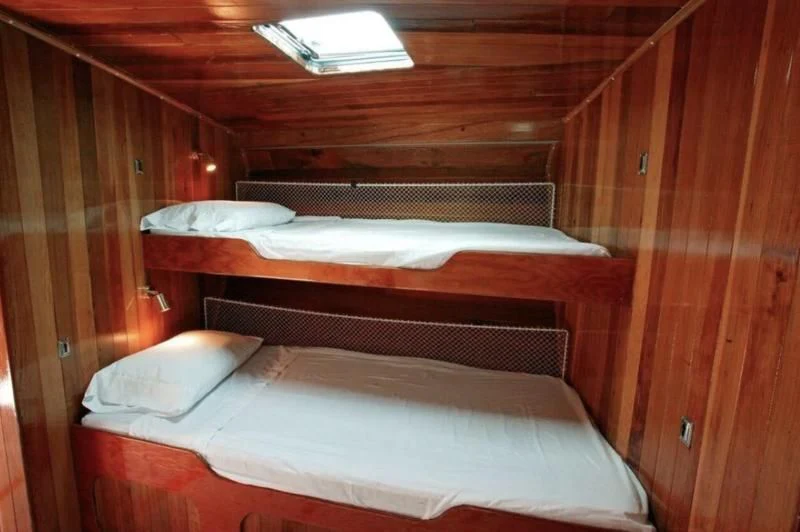 a couple of beds in a wooden room aboard CHRISTINE Yacht for Sale
