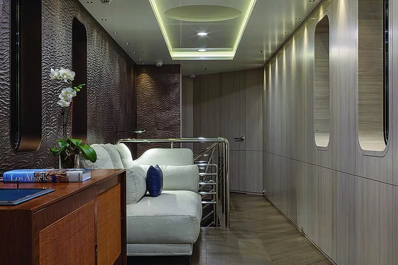 a room with a bed and desk aboard REVERIE Yacht for Sale