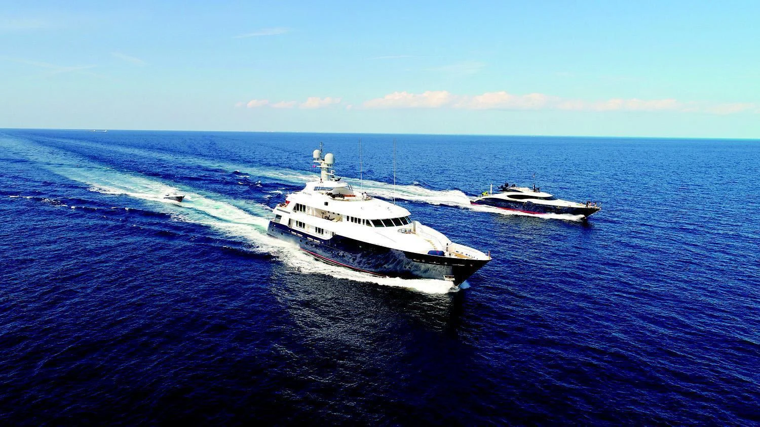 a couple of boats on the water aboard REVERIE Yacht for Sale