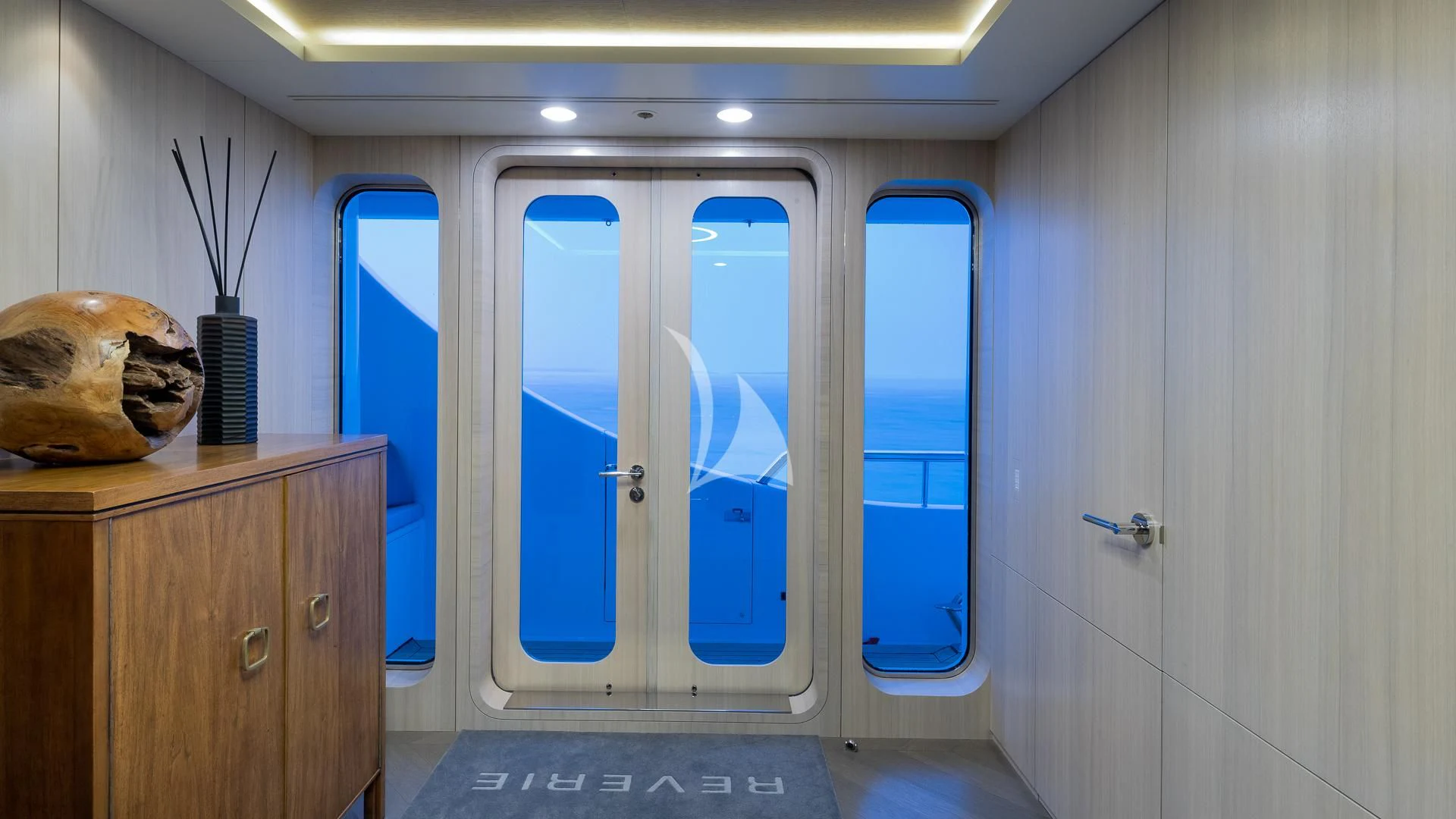a room with a large mirror and a door aboard REVERIE Yacht for Sale