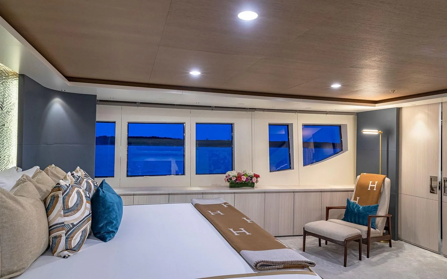 a room with a bed and a chair aboard REVERIE Yacht for Sale