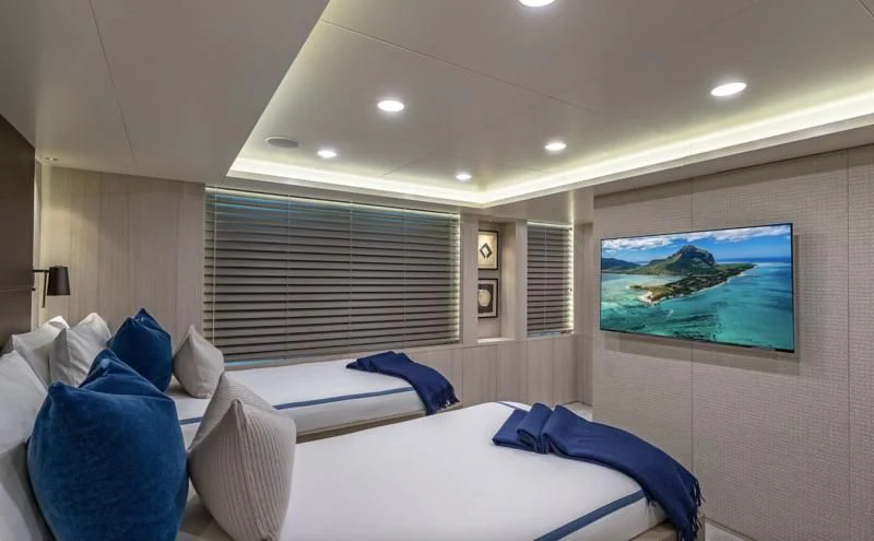 a room with a bed and a television aboard REVERIE Yacht for Sale