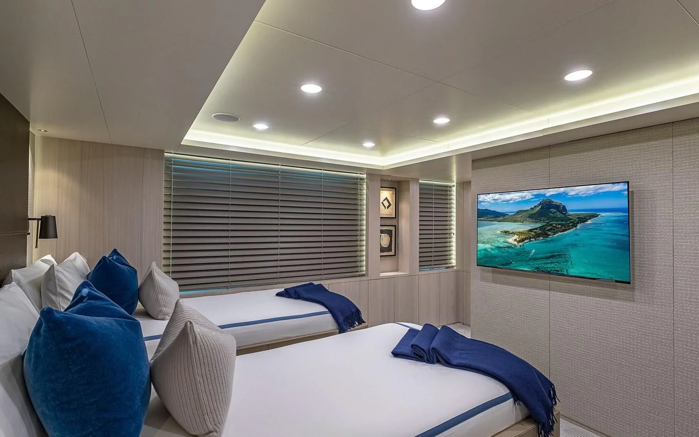 a room with a bed and a tv on the wall aboard REVERIE Yacht for Sale
