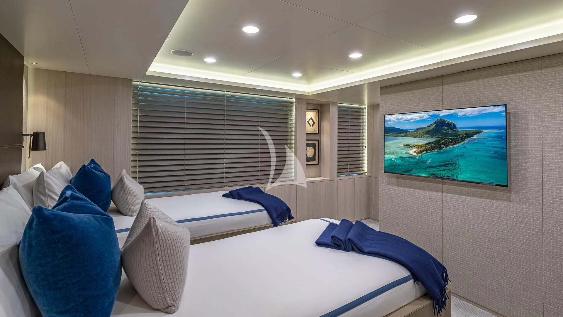 a bedroom with a bed and a tv on the wall aboard REVERIE Yacht for Sale