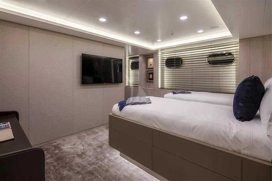 a room with a bed and a tv aboard REVERIE Yacht for Sale