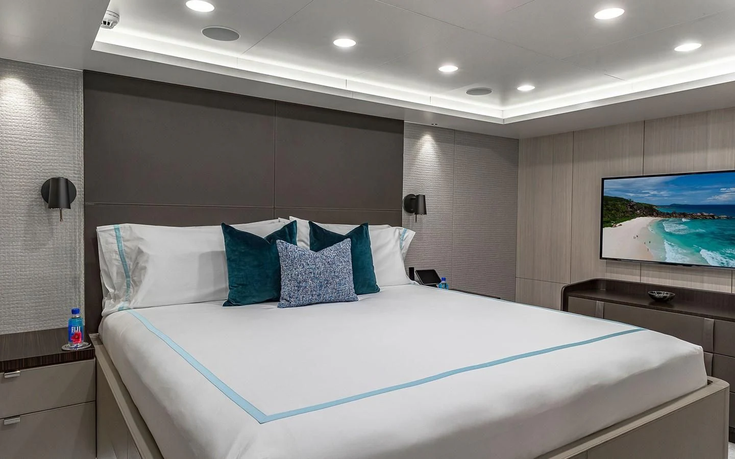 a bed with blue and white pillows aboard REVERIE Yacht for Sale