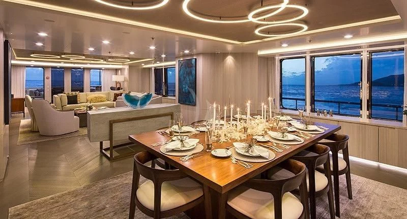 a large dining room with a table set for a meal aboard REVERIE Yacht for Sale