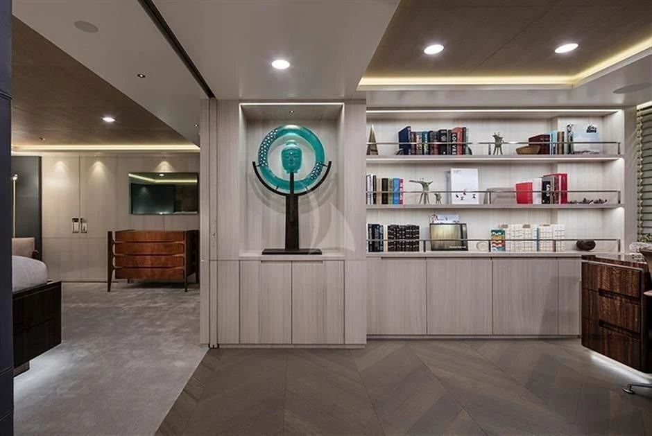 a room with a large mirror and a bookcase aboard REVERIE Yacht for Sale