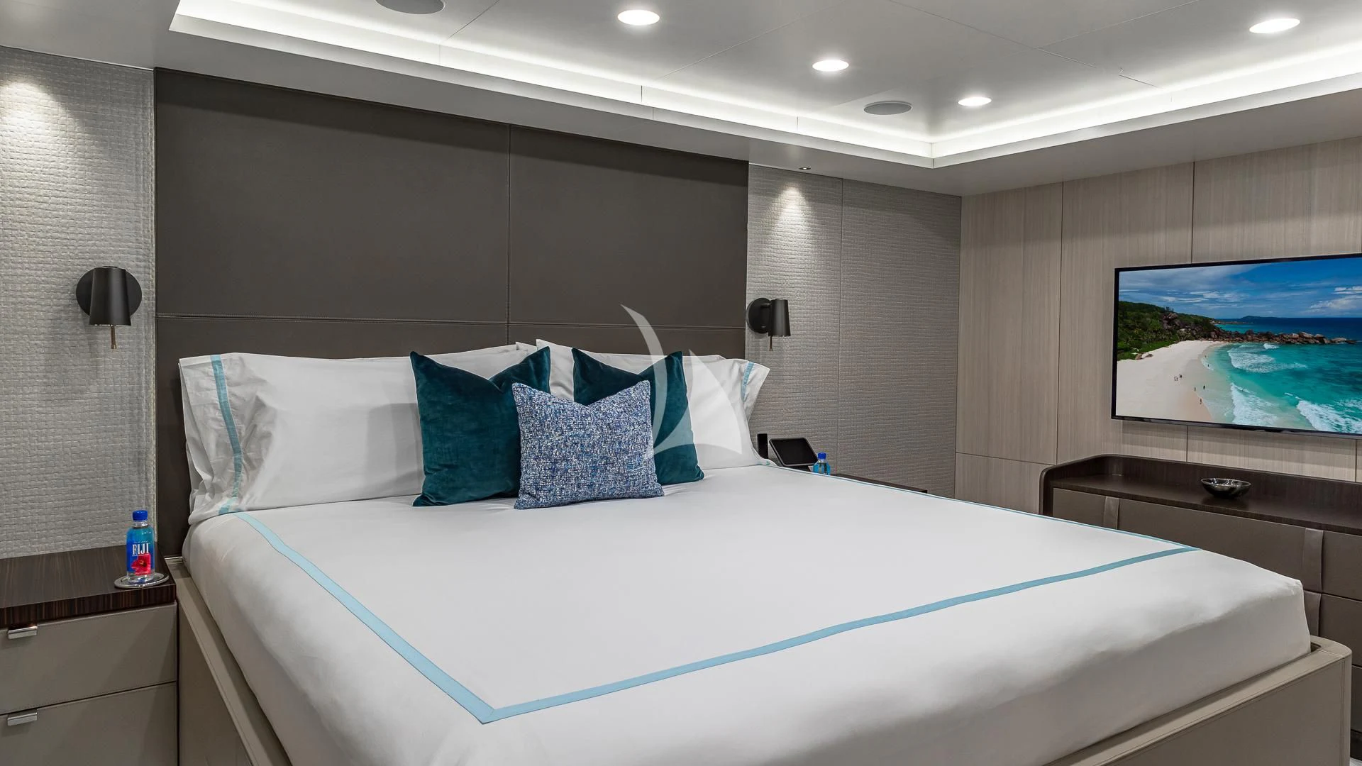 a bed with blue and white sheets aboard REVERIE Yacht for Sale