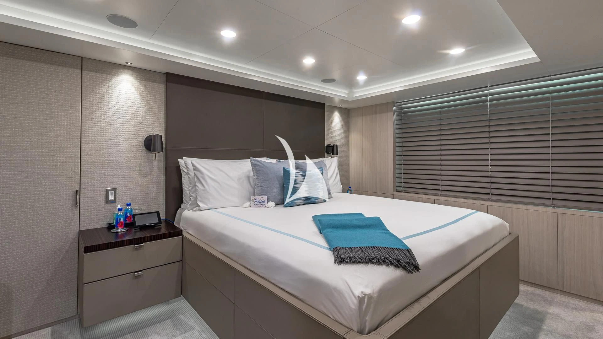 a bed with a blue pillow aboard REVERIE Yacht for Sale