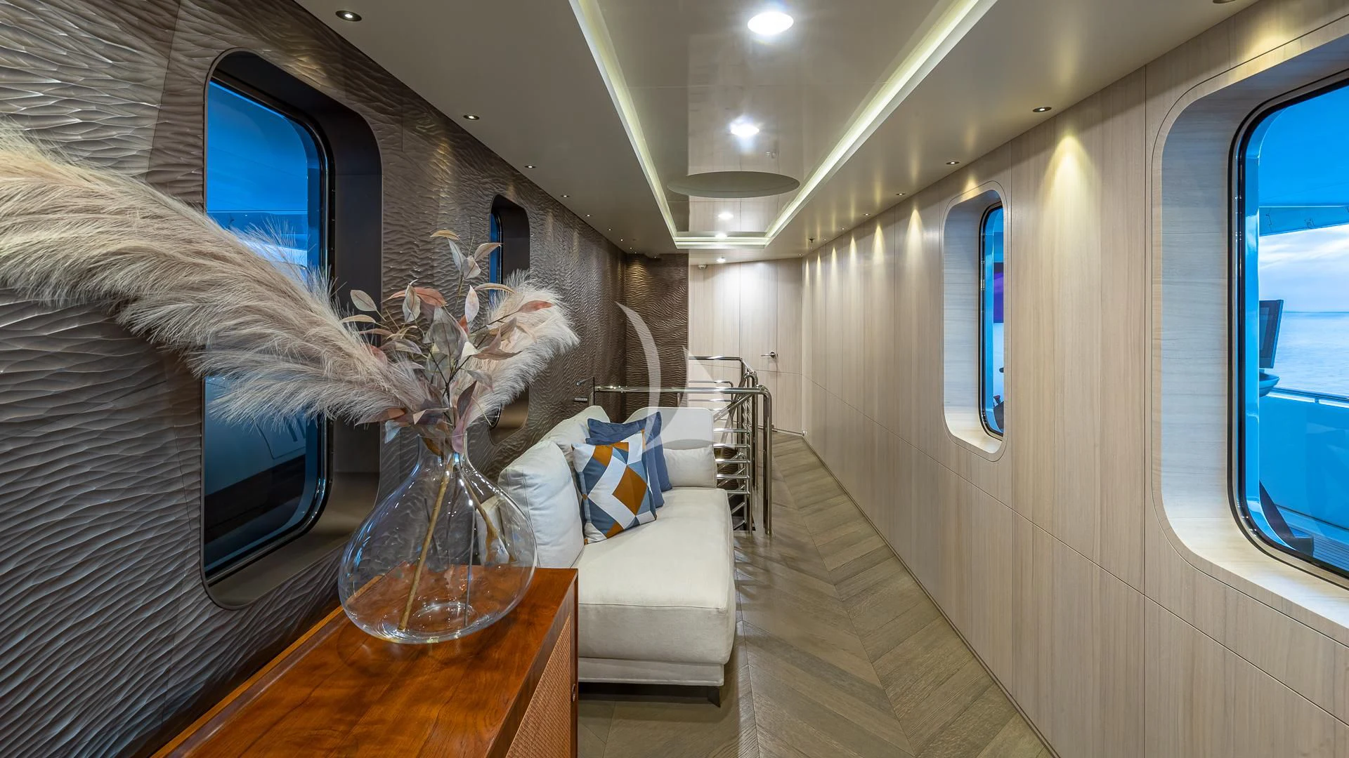 a person in a white dress in a room with a mirror and a table with chairs and a aboard REVERIE Yacht for Sale