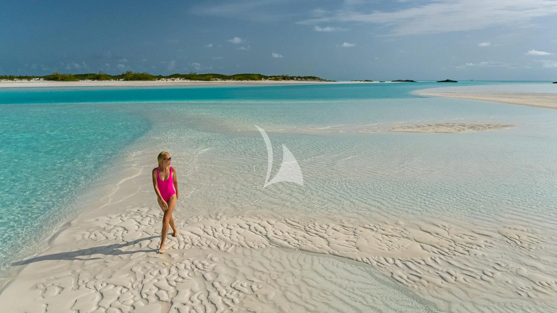 a person walking on a beach aboard REVERIE Yacht for Sale